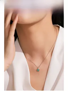 Model wearing a 925 sterling silver chain with a green enamel star pendant and zircon