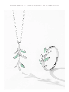 Detail view of 925 sterling silver olive branch jewelry set with green enamel finish