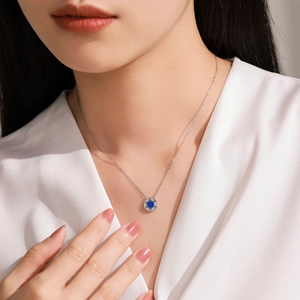 Elegant S925 silver necklace with royal blue halo star round pendant on female model