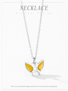 Detailed view of silver necklace featuring a vibrant yellow enamel butterfly pendant