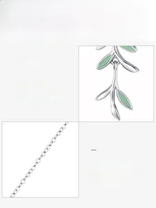 Macro shot of 925 sterling silver chain with green enamel leaf pendant details