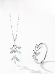 Detailed view of silver necklace and ring featuring green enamel leaf pendants