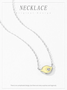 Detail of 925 silver lemon necklace with yellow enamel pendant and zircon crystal