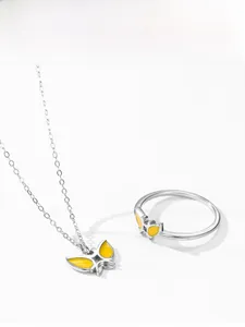 Detail of 925 sterling silver butterfly necklace and ring set with yellow enamel finish
