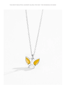 Close-up of yellow butterfly pendant in silver 925 with fine enamel detail and O-chain