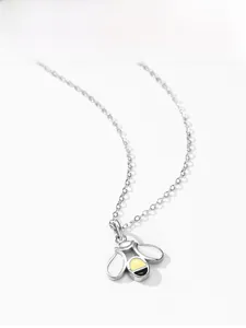 Close-up of a 925 sterling silver honey bee pendant with white enamel wings on a link chain