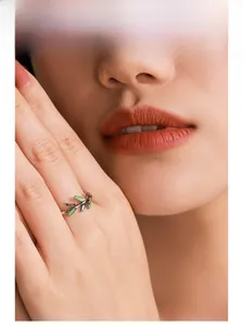 Close-up of S925 silver leaf ring with green enamel on a model hand, adjustable design