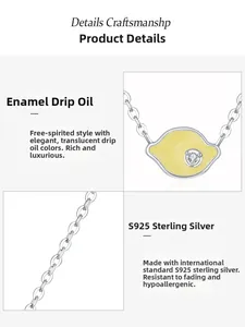 Detail of S925 sterling silver necklace with yellow enamel lemon pendant and small zircon