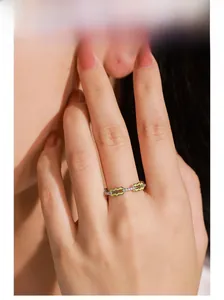Detail view of 925 silver wave ring with yellow enamel and sparkling zircon stones
