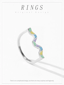 Macro shot of 925 sterling silver ring with colorful wavy enamel in macaron pastel shades