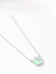 Detail of 925 silver necklace with light green enamel apple pendant and zircon leaf decoration