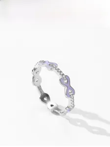 Detailed macro view of S925 sterling silver ring with purple enamel and cubic zirconia