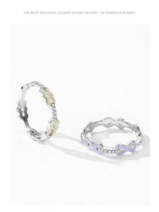 Close-up of S925 silver rings with purple infinity enamel and wave pattern details