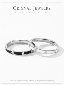 Macro shot of 925 sterling silver black and white enamel rings with small cubic zirconia stones