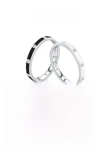Macro view of 925 sterling silver black and white enamel rings with inlaid sparkling diamonds