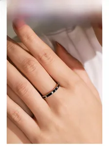 Detail of 925 sterling silver ring with black enamel and sparkling cubic zirconia stones