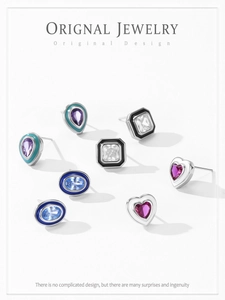 Detail of 925 silver earring set with colorful enamel heart and geometric shapes
