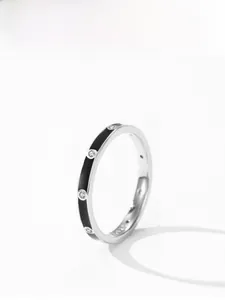 Detailed view of 925 sterling silver ring with black enamel and embedded small diamonds