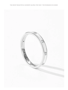 Macro detail of S925 sterling silver ring with white zircon stones and inner engraving