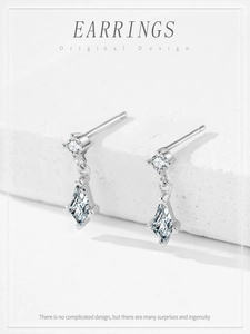 Detail of 925 silver geometric earrings with sparkling diamond-cut zircon stones