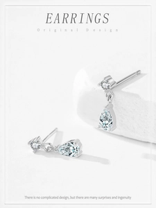 Close-up of 925 silver pear-shaped drop earrings with brilliant cubic zirconia accents