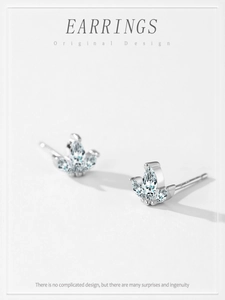 Detail of silver S925 crown stud earrings with three marquise-cut marquise stones