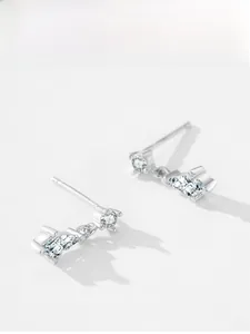 Detail of 925 sterling silver earrings with triangle zircon in a geometric French style