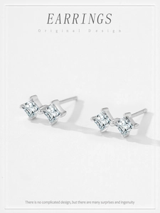 Macro detail of S925 silver star earrings with square zirconia stones in a minimalist style