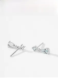 Detail view of 925 sterling silver tassel earrings with round and pear-shaped zircon stones