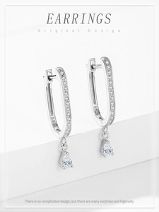 Macro detail of S925 sterling silver U-shaped earrings with pear-cut crystals