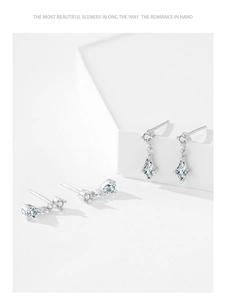 Close-up of 925 sterling silver drop and rhombus cubic zirconia dangle earrings