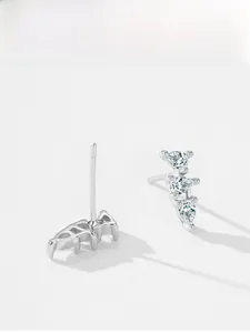 Detail of 925 silver stud earrings featuring three vertical pear-cut blue gemstones