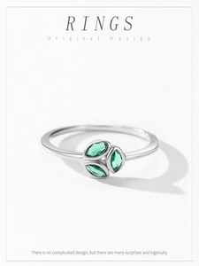 Macro shot of 925 silver ring featuring three marquise-cut green gemstones in a fan layout
