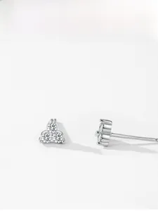 Macro shot of 925 sterling silver three-stone cluster stud earrings with zircon crystals
