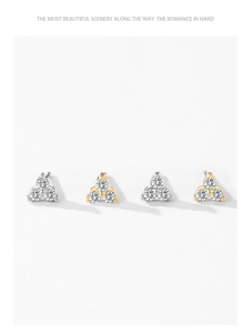 Macro detail of gold and silver triangle stud earrings with three micro-pave zircons