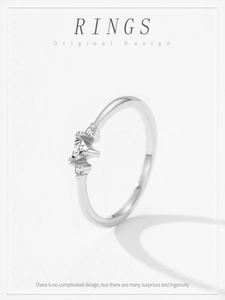 Macro view of 925 sterling silver ring with central triangle cut stone on white background