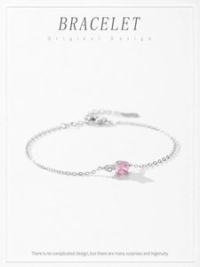 Detailed macro view of S925 sterling silver chain with a pink round gemstone and tiny diamond