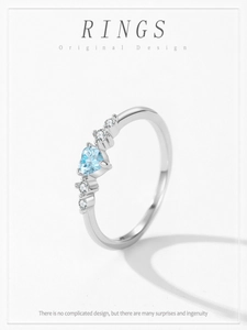 Macro detail of S925 silver ring featuring a blue heart gemstone and sparkling side diamonds