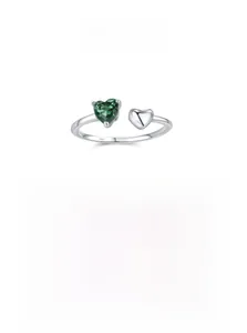 Detailed macro view of S925 silver ring featuring heart green stone and engraved logo