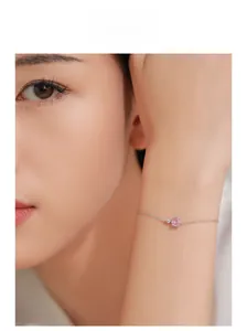 Close-up of S925 silver bracelet featuring a pink square gem and small round diamond