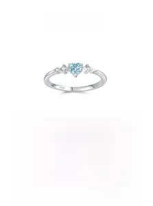 Macro shot of S925 sterling silver stamp and heart-shaped light blue gemstone ring