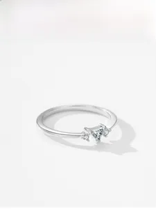 Detailed view of silver minimalist ring with triangle cut rhinestone on white background