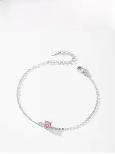 Detail of S925 sterling silver bracelet with pink gemstone and lobster clasp closure