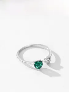 Detail of 925 silver open ring featuring a double heart design with green cubic zirconia