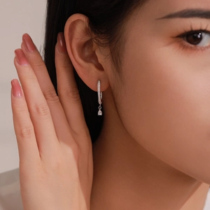 Elegant 925 sterling silver U-shaped drop earrings with pear-cut crystal on a female model