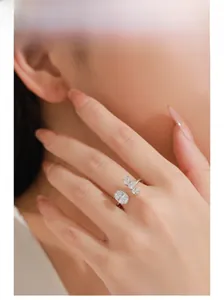 Close-up of 925 silver open ring with oval solitaire diamond worn on a finger