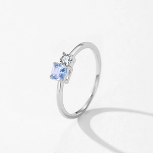 Elegant S925 silver ring featuring light blue princess square and round white gems