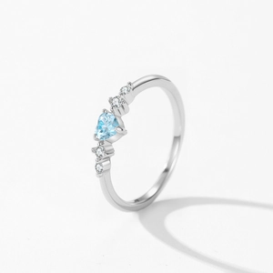 S925 silver ocean heart ring with ice blue gemstone and side diamonds on white background