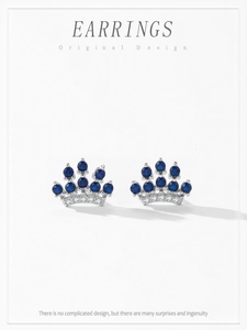 Macro detail of S925 silver crown earrings featuring blue sapphires and fine micro-diamonds