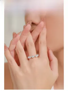 Close-up of S925 silver ring featuring three oval-cut diamonds on a model hand